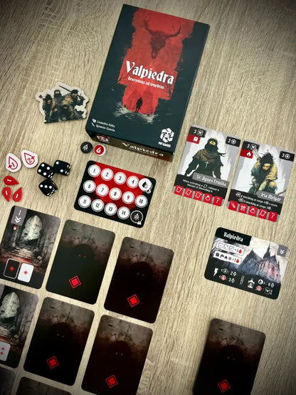 Juego de mesa Valpiedra: Descensus ad Tenebras con caja, cartas, dados y fichas sobre una mesa de madera